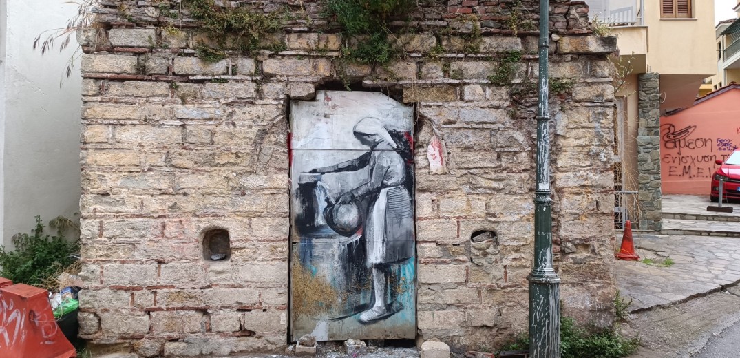 Άνω Πόλη: Μια ζωγραφισμένη γυναίκα «κερνάει» νερό σε πόρτα εγκαταλειμμένης παλιάς κρήνης	